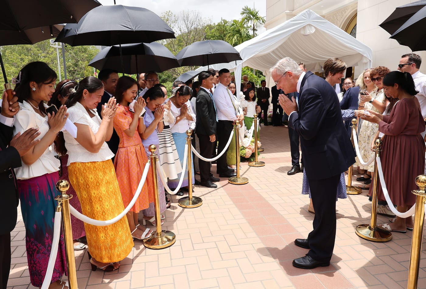 Elder Patrick Kearon greeting members outside the Phnom Penh Cambodia Temple on the day of its dedication